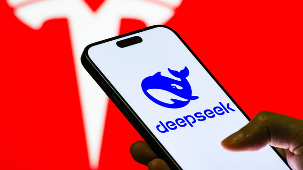 2025年8月21日：這張照片顯示，一手拿著智慧型手機，手機螢幕上顯示中國人工智慧公司DeepSeek的標誌，而特斯拉的標誌則位於其前方。