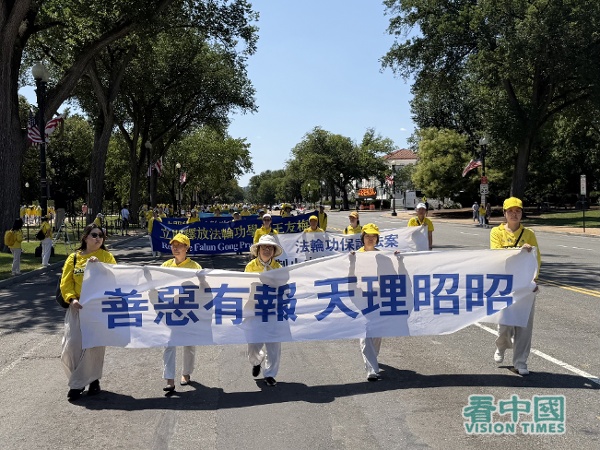 遊行隊伍的第三方陣,法輪功學員拉著「善惡有報 天理昭昭」的橫幅