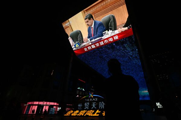 一塊位於購物中心外的巨型屏幕播放新聞畫面，內容為委內瑞拉總統尼古拉斯．馬杜羅於2023年9月13日在北京會見中國國家主席習近平（畫面中未出現）。